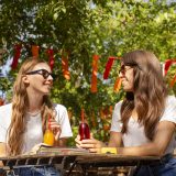 Friends park holding fresh juice bottles